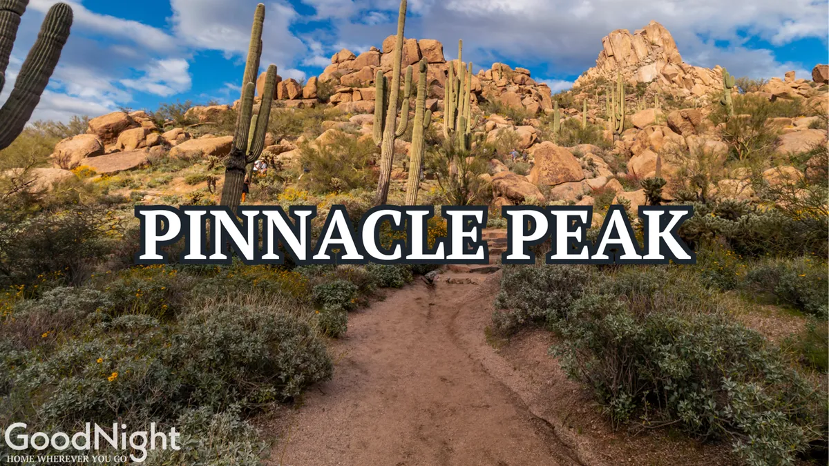 This image features the striking Pinnacle Peak rising from the desert landscape, with rocky outcrops and saguaro cacti in the foreground. The expansive sky and sunlit trails evoke the spirit of Arizona’s renowned hiking destinations.